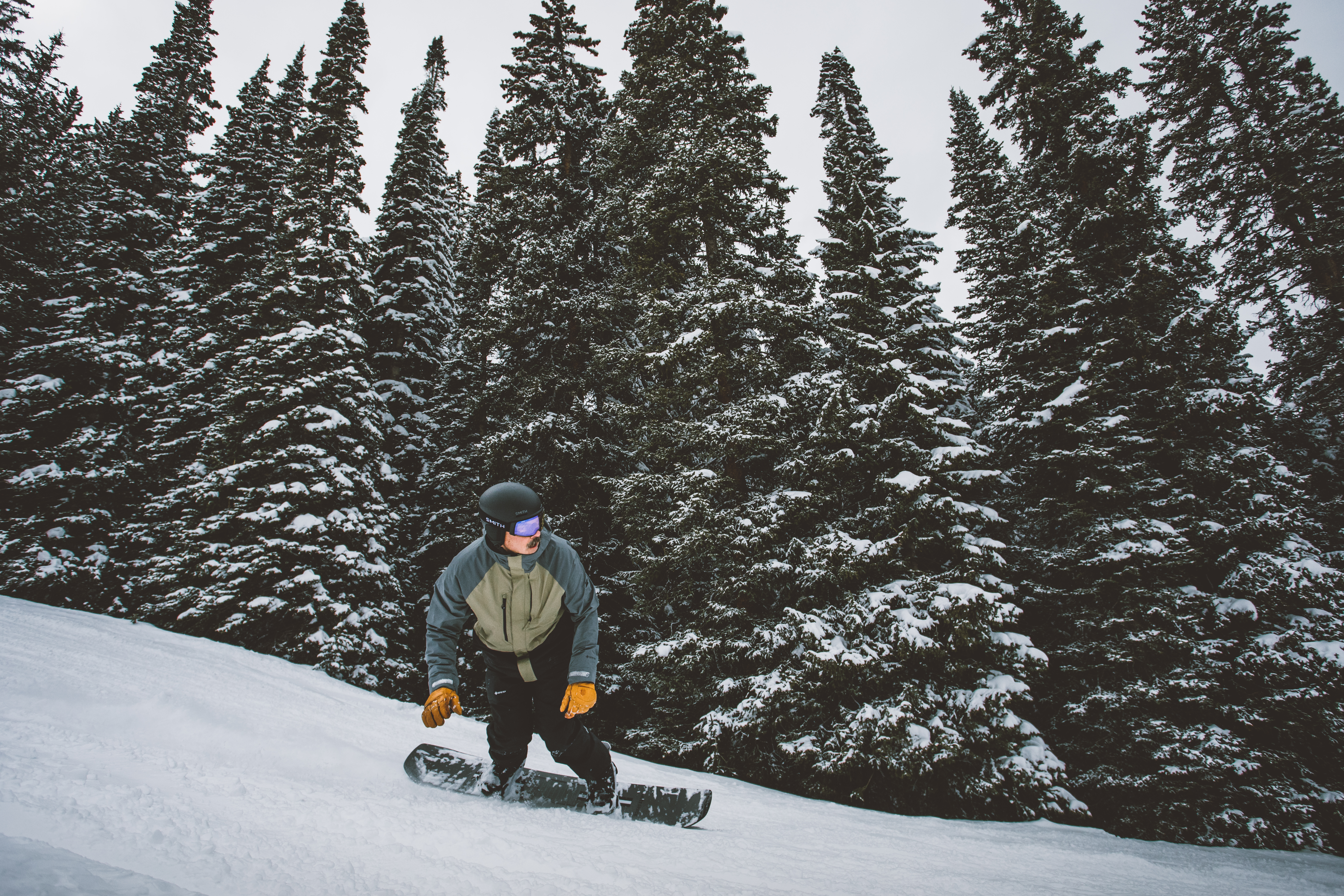 Man Snowboarding on a Board from Sun & Ski Sports
